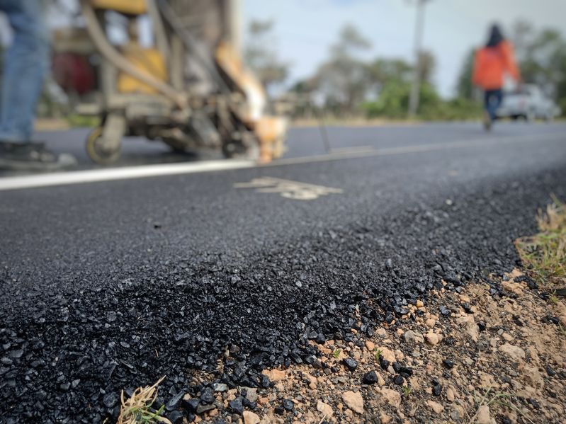 Technicians are using traffic marking machines.