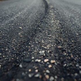 asphalt road with small stones in the foreground. toned.